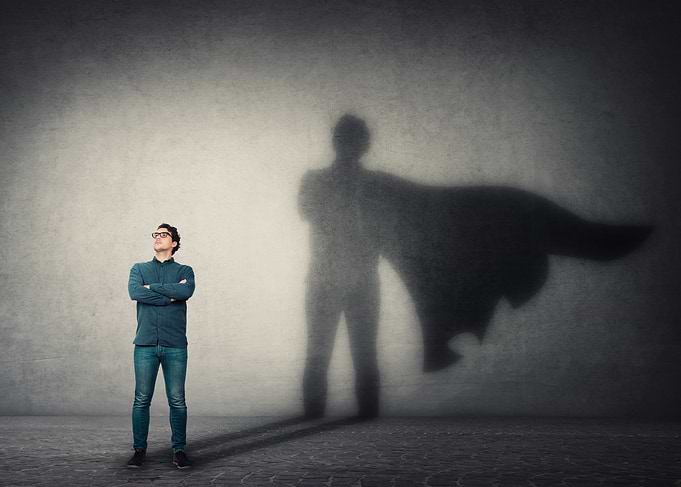 Man with Superhero Shadow on Wall