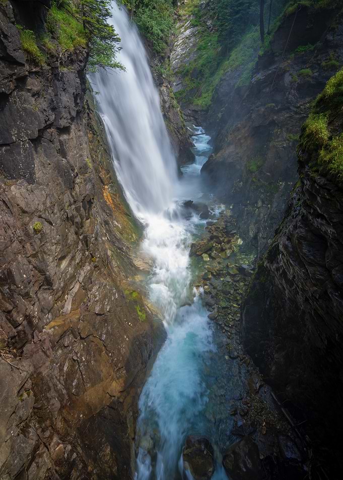 Waterfall cascading through rocky gorge