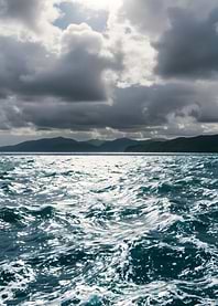 Ocean waves under a cloudy sky