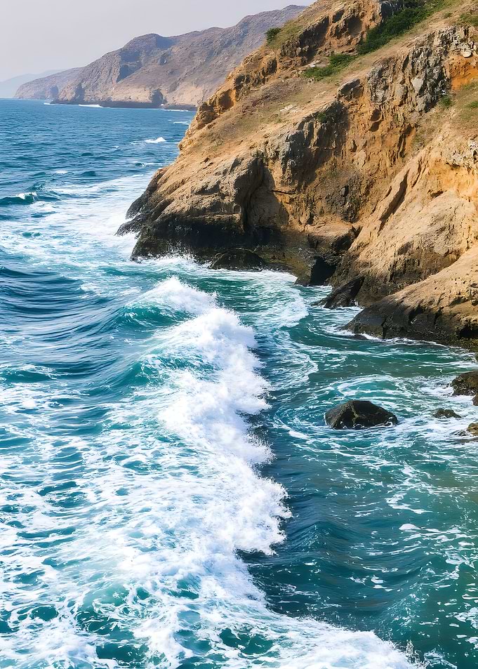 Coastal Waves Crashing on Rocky Shore