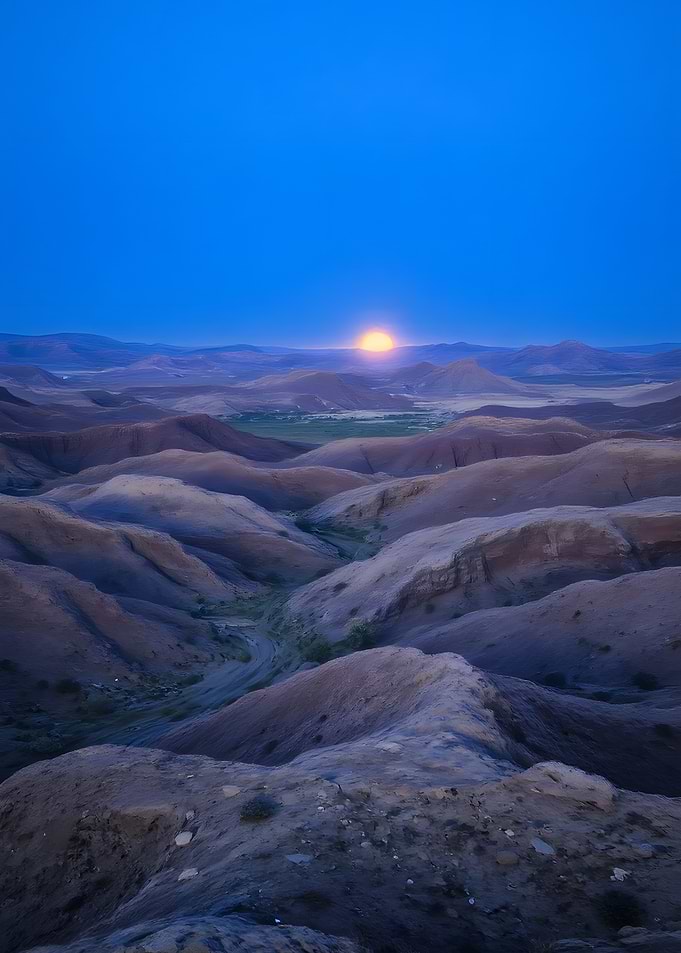 Sunrise over a hilly landscape