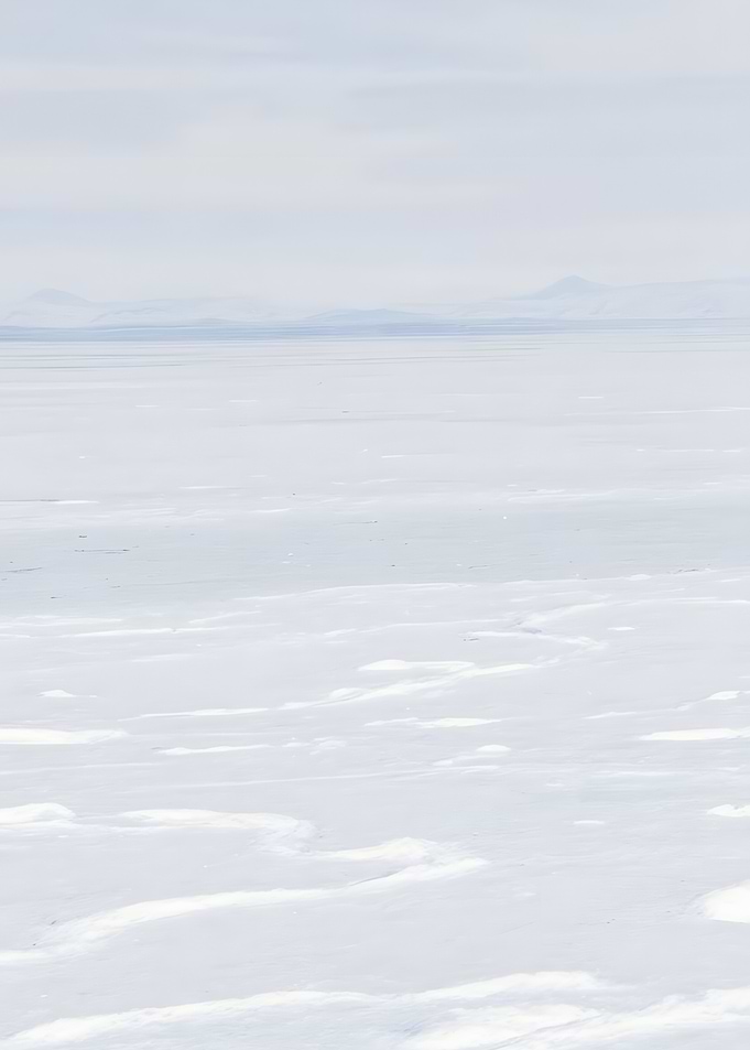 Snowy landscape with distant mountains