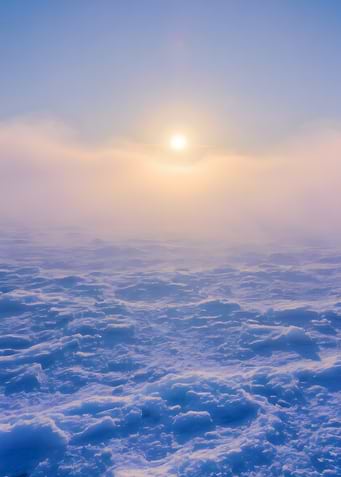Snowy landscape with sun and fog