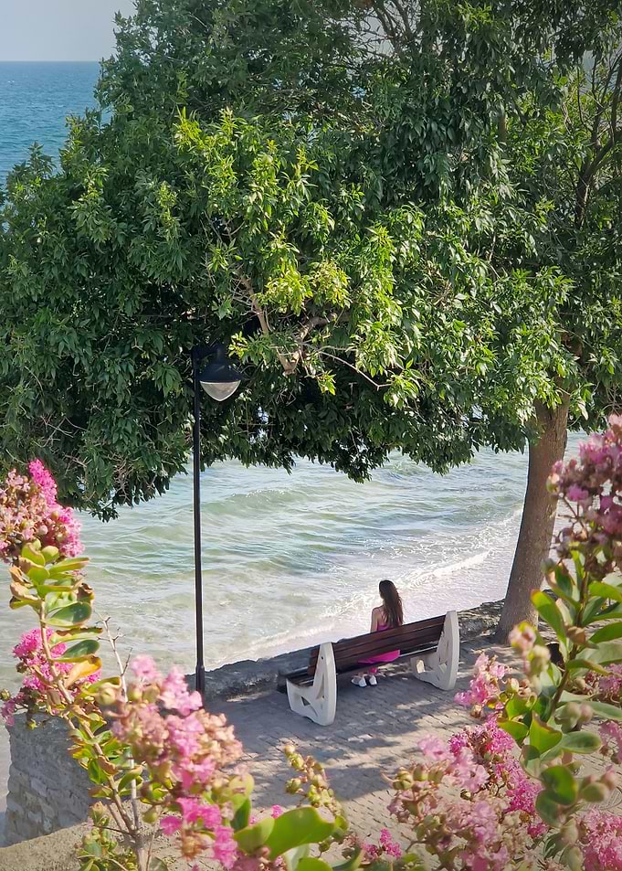 Woman on bench by the sea