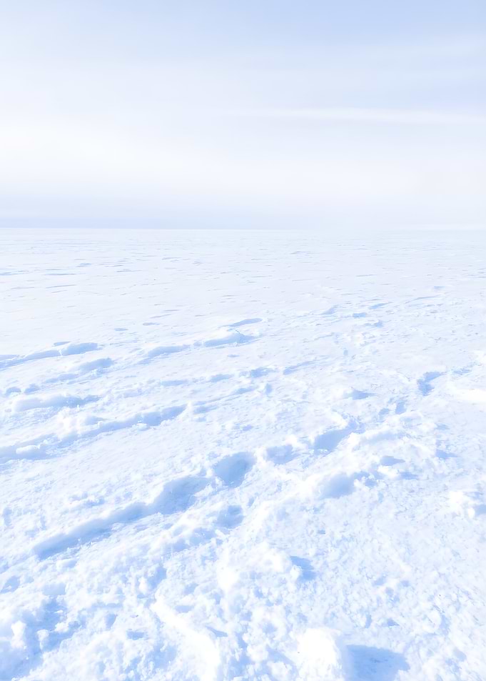 Snowy expanse under a pale sky