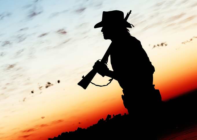 Silhouette of a Cowboy with Rifle