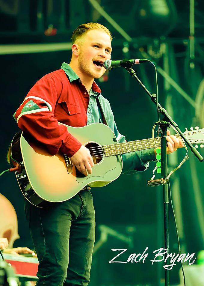 Zach Bryan performing with guitar