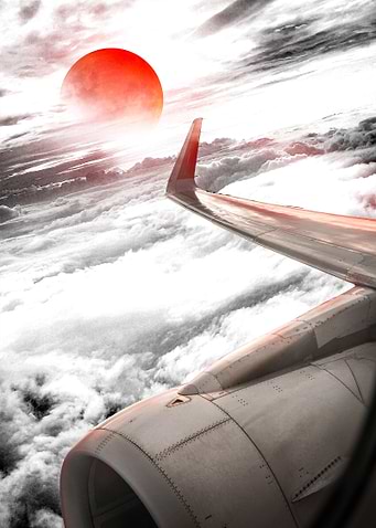 Airplane Wing View with Red Sun
