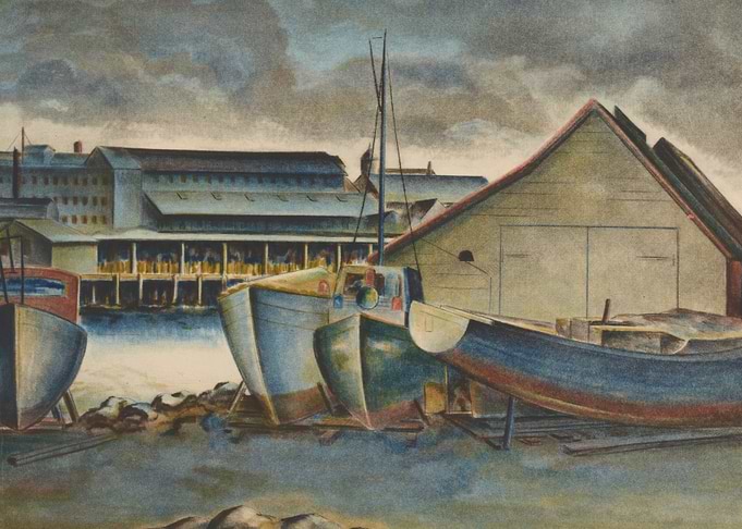 Boats docked at a harbor with a building