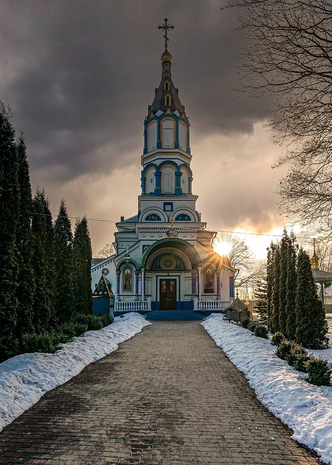Chernobyl church with snowy path and dramatic sky