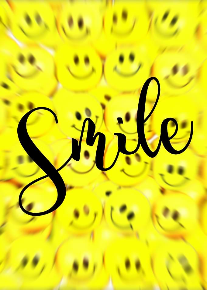 Smile Text on Blurred Smiley Faces