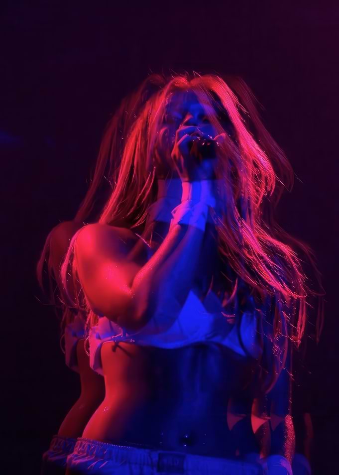 Singer performing under red and blue lights