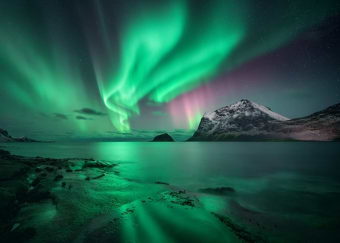 Aurora Borealis over Arctic Landscape in Lofoten Islands, Norway
