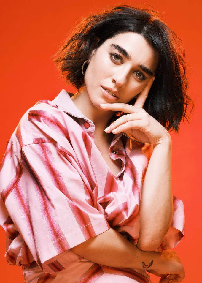 simona tabasco in striped shirt against red background