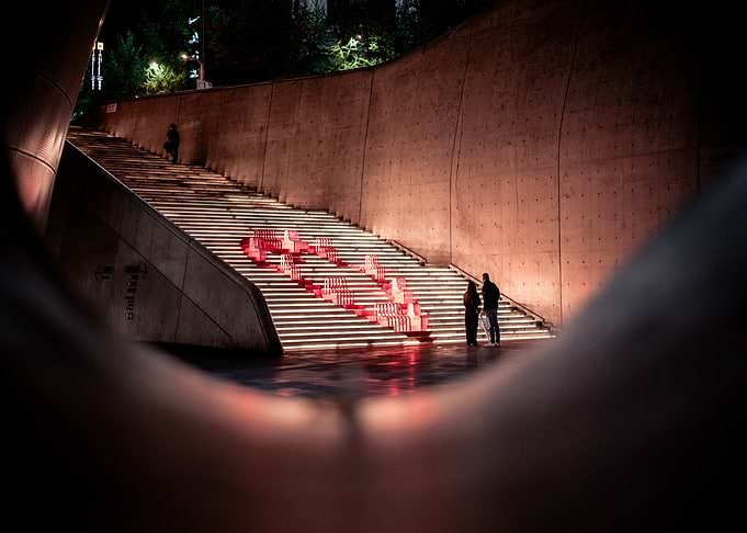 Illuminated Staircase with Red Sculptures at DDP