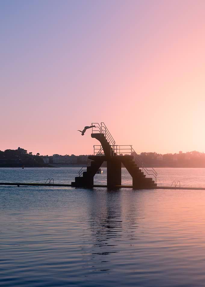Diver silhouetted against sunset