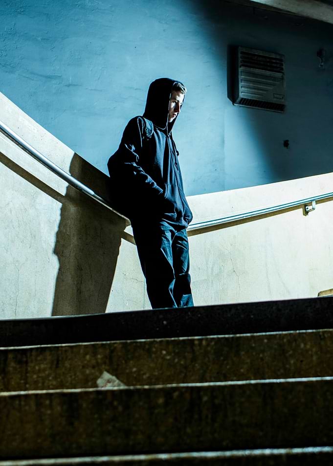 Teenager in Hoodie on Stairs