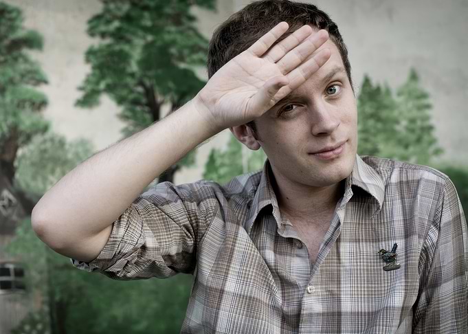 jens lekman shielding eyes with hand