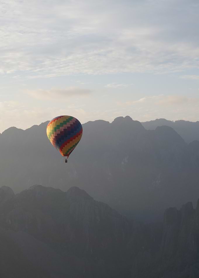 Hot Air Balloon Over Mountains