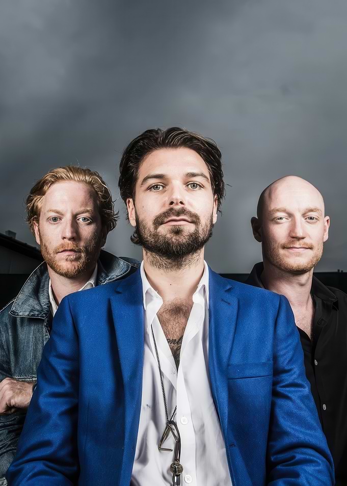 Three men posing for a photo