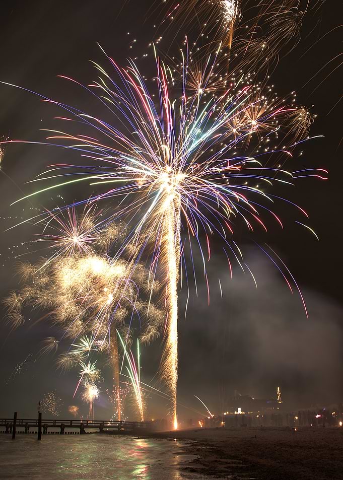 Fireworks over a pier and beach