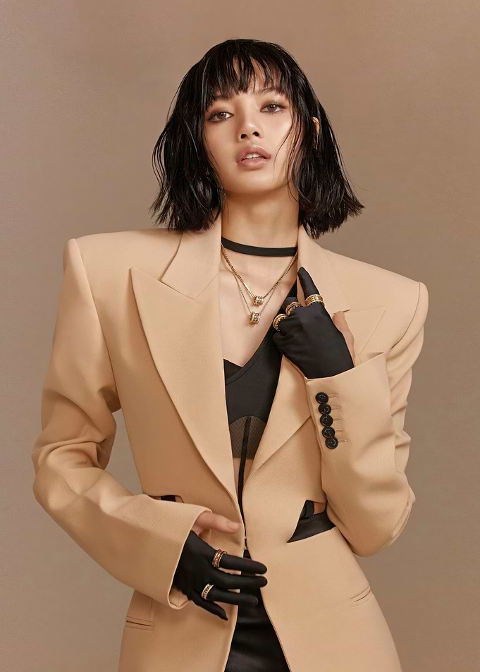 Lisa in a beige blazer and black gloves
