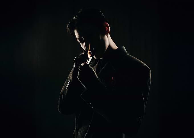 bambam lighting a pipe in silhouette