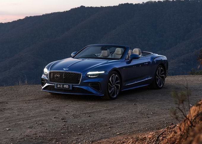 Blue Bentley Convertible on a Mountain Road