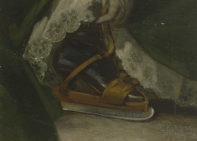 Close-up of a woman's ice skate and lace trim