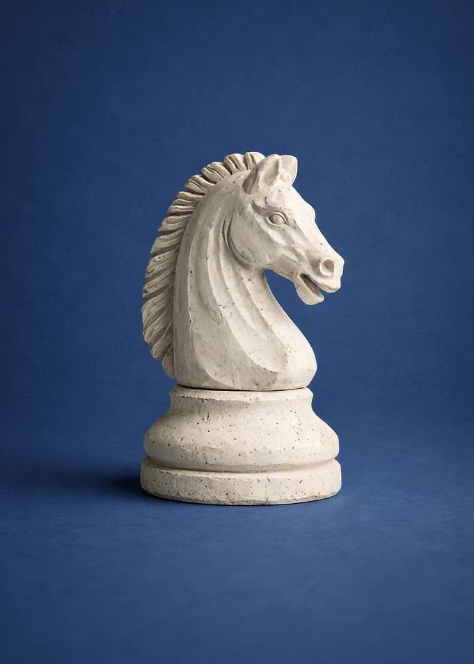 White Chess Knight on Blue Background