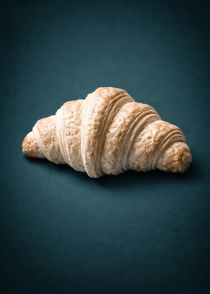 Golden Croissant on Dark Teal Background