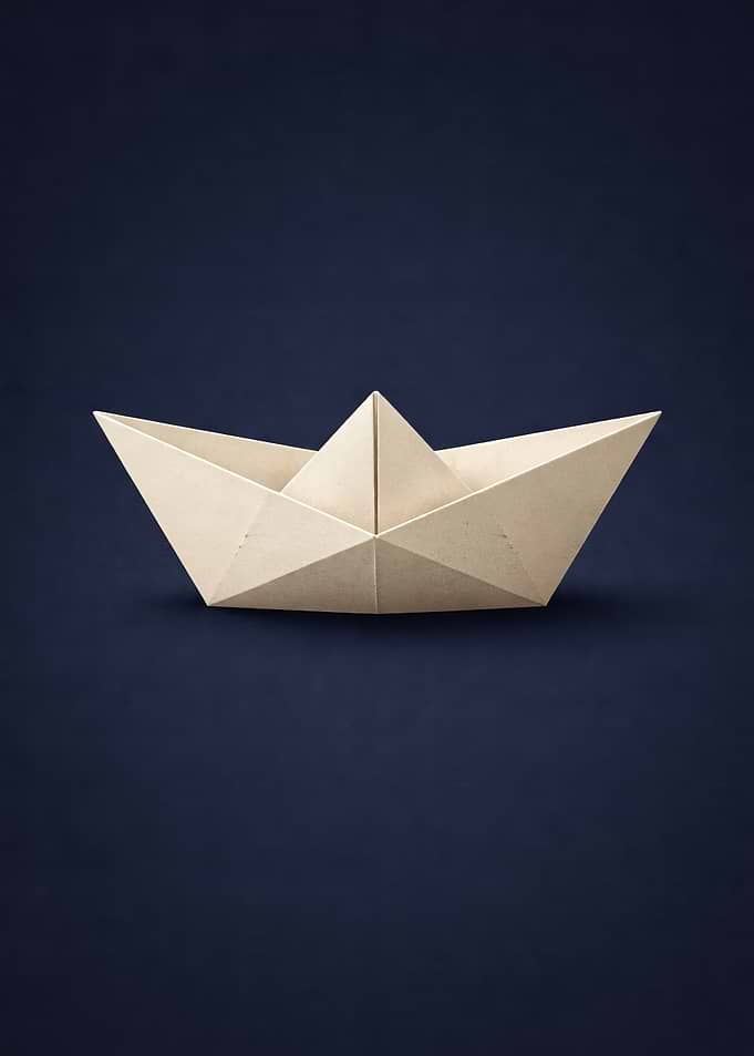 Origami Paper Boat on Dark Blue Background