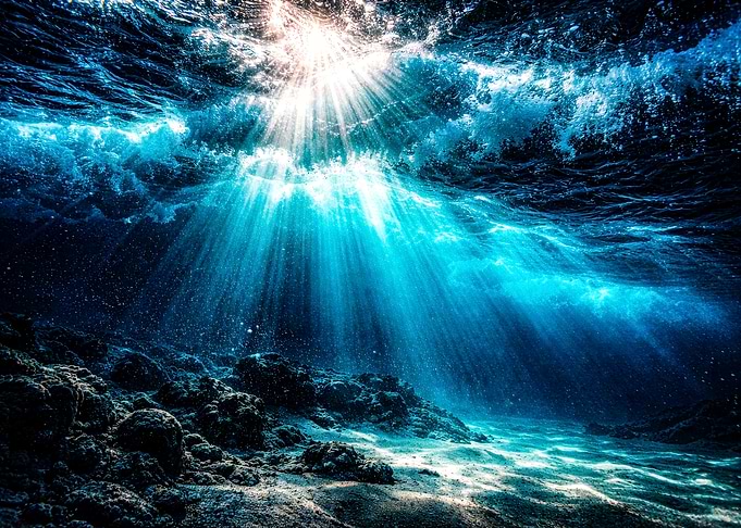 Underwater Sunbeams on Rocky Seabed
