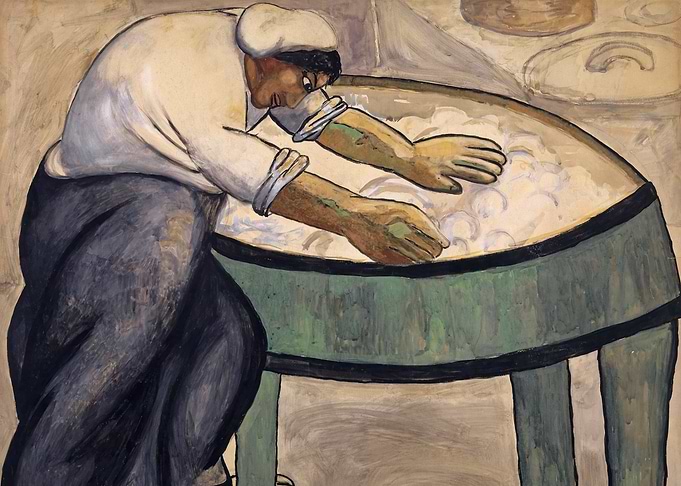 Worker washing clothes in a tub