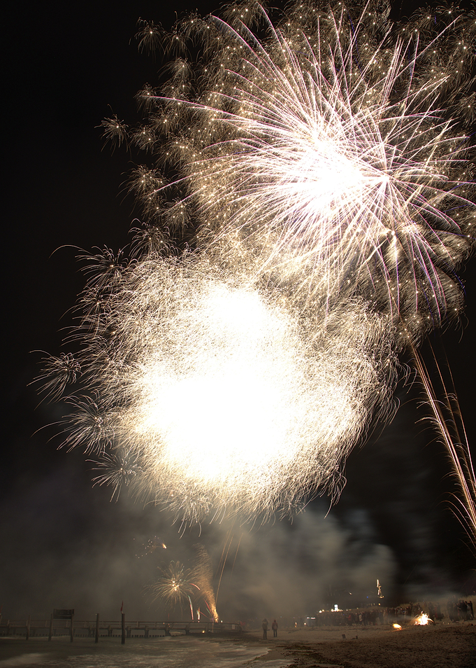 Fireworks over a beach at night