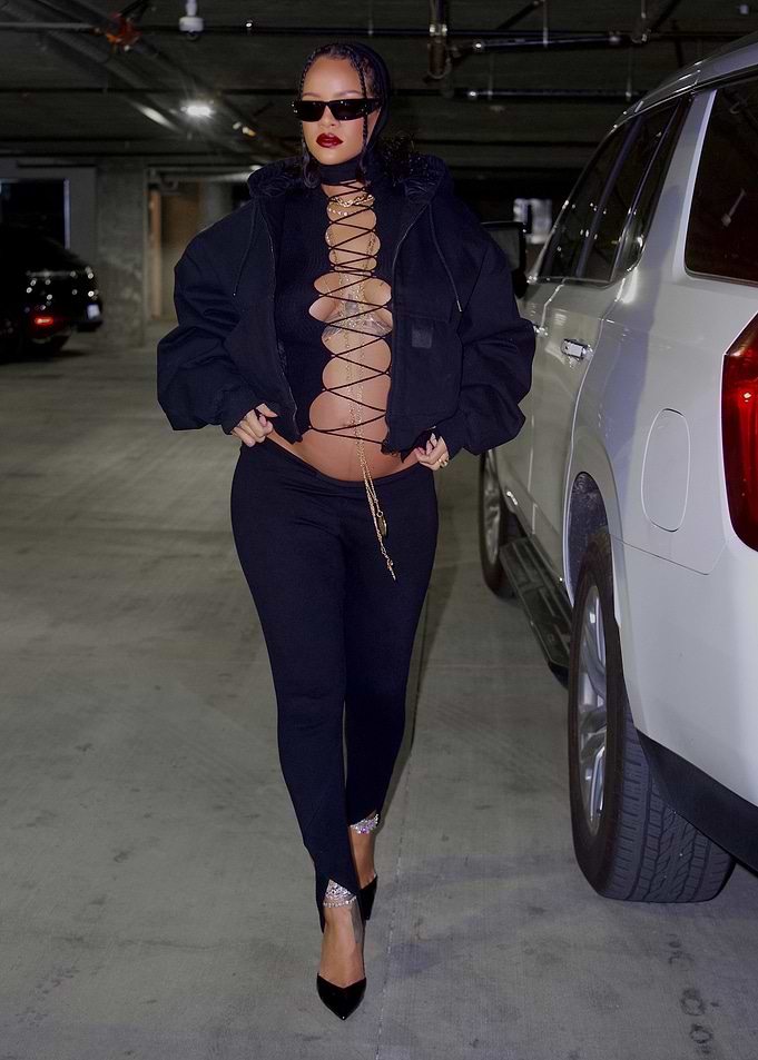 Rihanna in a black lace-up top and pants