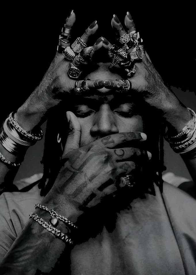Don Toliver hands on head and face