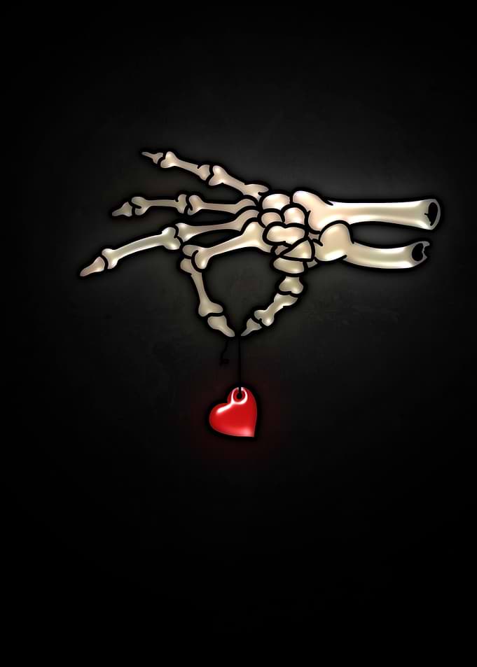 Skeleton Hand Holding Red Heart