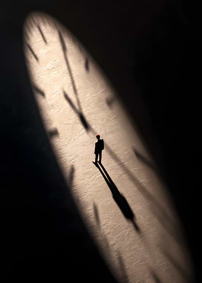 Man standing on a clock face shadow