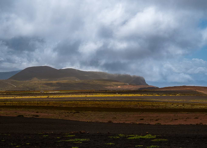 Volcanic Landscape Under Cloudy Sky