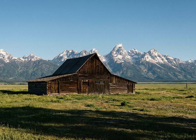 Rustic Barn with Snow-Capped Mountains