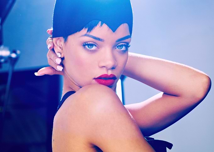 Rihanna in a black headpiece and red lipstick