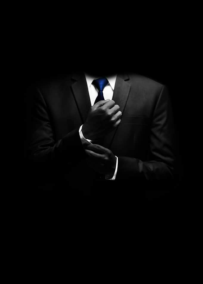 Man in Suit Adjusting Tie
