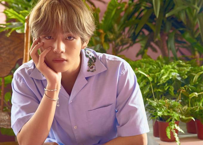 V with hand on face