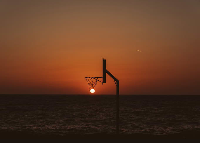 Sunset basketball hoop over the ocean