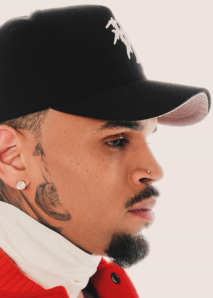Chris Brown in Black Cap and Red Jacket