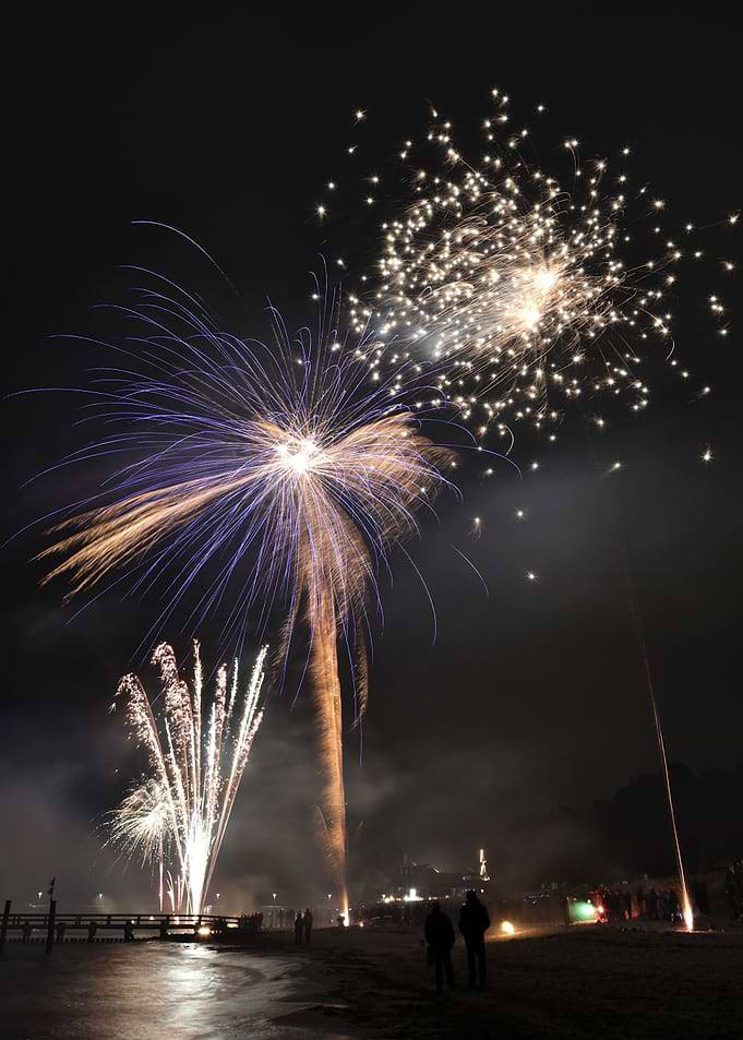 Fireworks over a beach at night