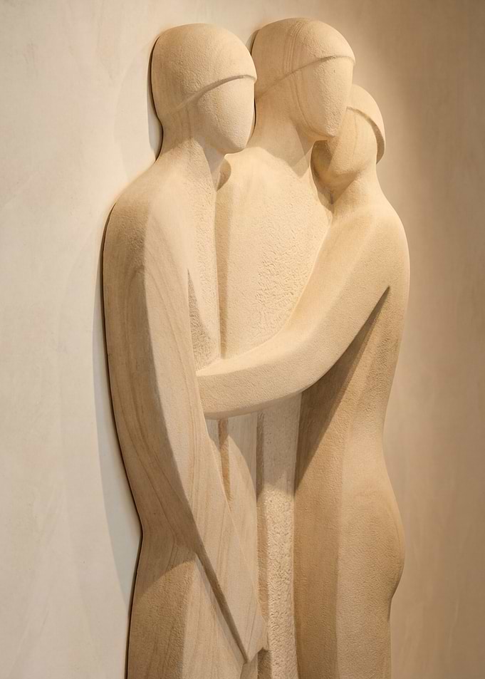 Sculpture of three embracing figures