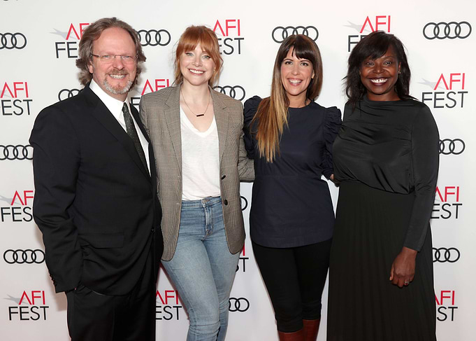 Four people posing at an event