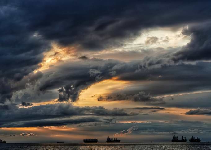 Stormy Sunset Over the Ocean with Ships